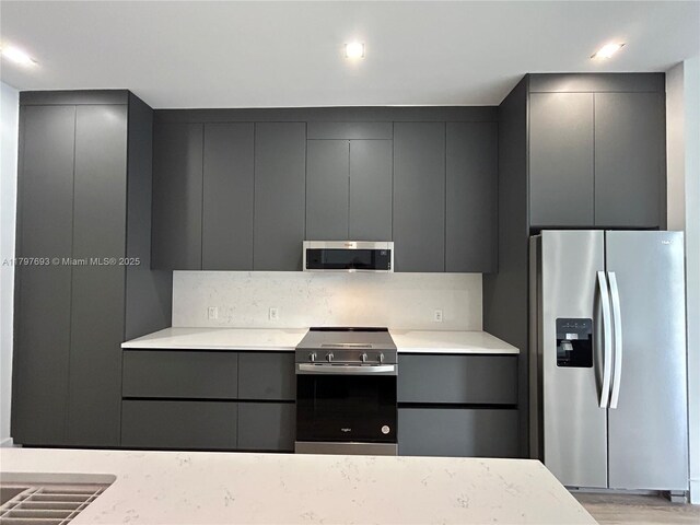 1611 SW 30th Ave, Fort Lauderdale, FL 33312 - kitchen featuring light countertops, gray cabinets, stainless steel appliances, and modern cabinets