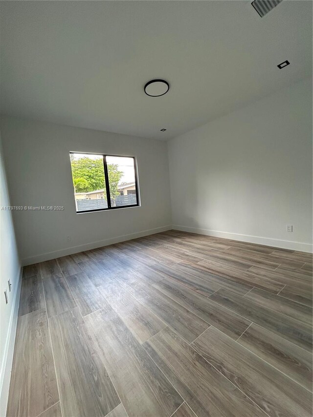 1611 SW 30th Ave, Fort Lauderdale, FL 33312 - unfurnished room featuring visible vents, wood finished floors, and baseboards
