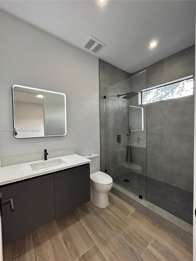 1611 SW 30th Ave, Fort Lauderdale, FL 33312 - bathroom featuring toilet, visible vents, a shower stall, vanity, and wood finished floors