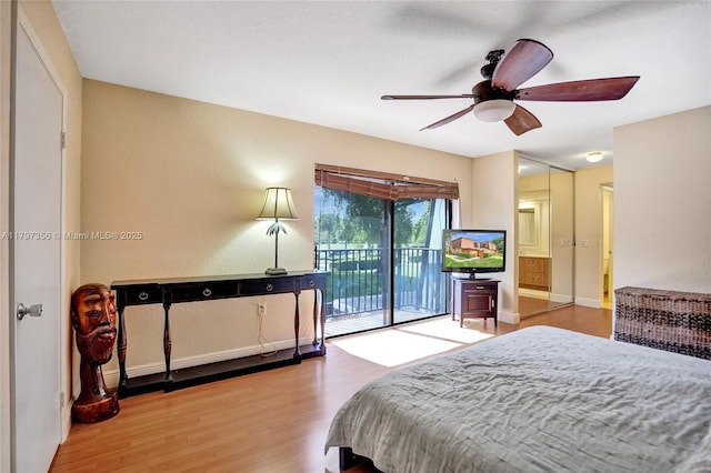 bedroom with a ceiling fan, wood finished floors, and access to exterior