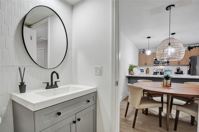 9136A SW 20th Pl, Davie, FL 33324 - bathroom with wood finished floors, vanity, baseboards, and backsplash