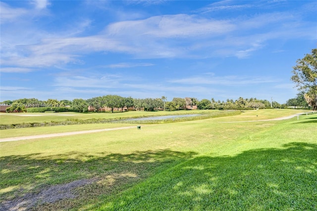 view of home's community featuring a yard, a water view, and golf course view