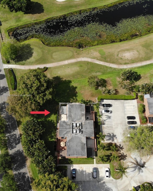 birds eye view of property with a water view and golf course view
