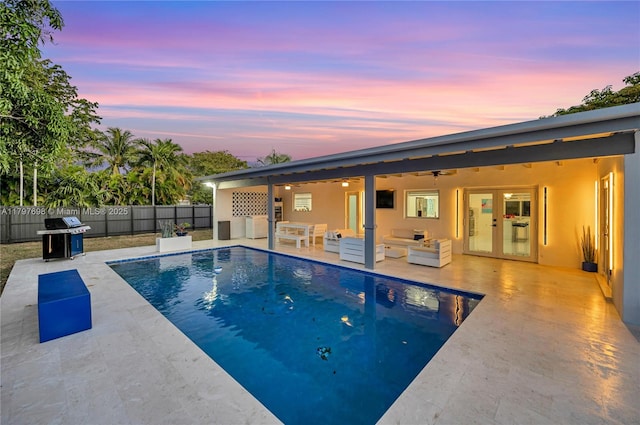 8501 SW 142nd St, Palmetto Bay, FL 33158 - pool at dusk with french doors, grilling area, a fenced backyard, ceiling fan, and a patio area