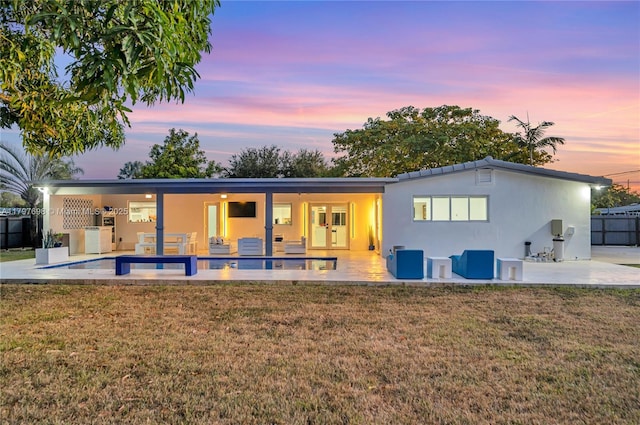 8501 SW 142nd St, Palmetto Bay, FL 33158 - back of house featuring a patio, stucco siding, fence, a lawn, and an outdoor pool