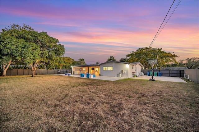 8501 SW 142nd St, Palmetto Bay, FL 33158 - yard at dusk with a patio and a fenced backyard
