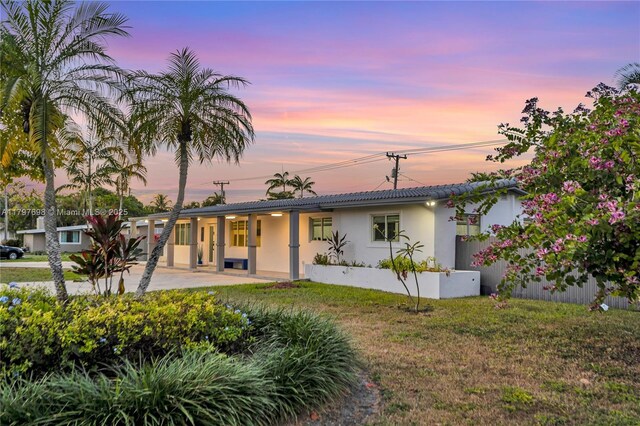 8501 SW 142nd St, Palmetto Bay, FL 33158 - back of house with a tiled roof, stucco siding, and a lawn