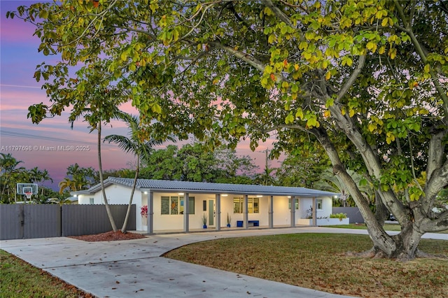 8501 SW 142nd St, Palmetto Bay, FL 33158 - view of front of home featuring fence, driveway, stucco siding, and metal roof