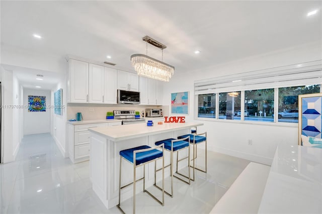8501 SW 142nd St, Palmetto Bay, FL 33158 - kitchen featuring stainless steel appliances, light tile patterned flooring, a sink, white cabinetry, and light countertops