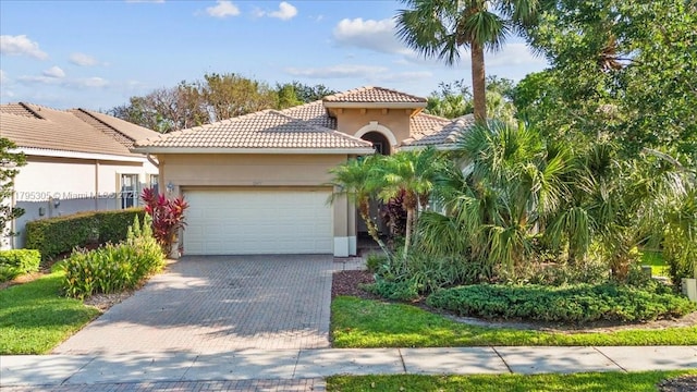 12471 NW 78th Mnr, Parkland, FL 33076 - mediterranean / spanish-style home with a tiled roof, an attached garage, decorative driveway, and stucco siding