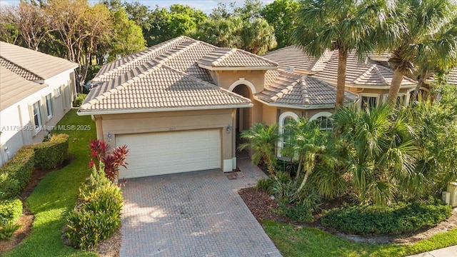 12471 NW 78th Mnr, Parkland, FL 33076 - view of front facade with a garage, stucco siding, driveway, and a tile roof