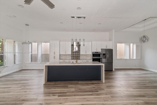 12471 NW 78th Mnr, Parkland, FL 33076 - kitchen with appliances with stainless steel finishes, a sink, light countertops, baseboards, and recessed lighting