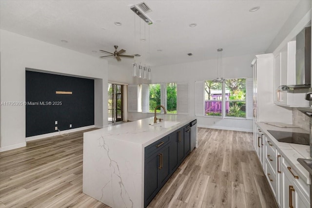 12471 NW 78th Mnr, Parkland, FL 33076 - kitchen featuring a sink, black electric stovetop, white cabinetry, dishwasher, and light wood finished floors