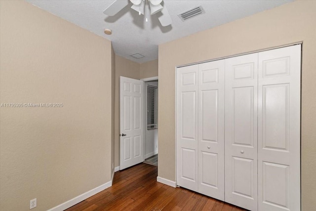 12471 NW 78th Mnr, Parkland, FL 33076 - unfurnished bedroom with dark wood finished floors, baseboards, a closet, and a ceiling fan