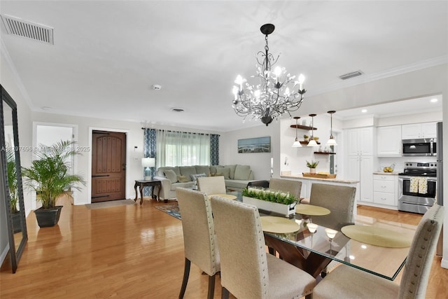 3921 Roosevelt St, Hollywood, FL 33021 - dining room featuring light wood finished floors, a chandelier, crown molding, and recessed lighting
