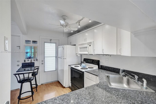 455 Paradise Isle Blvd Unit 209, Hallandale Beach, FL 33009 - kitchen with a sink, white appliances, ceiling fan, light wood-style flooring, and white cabinetry