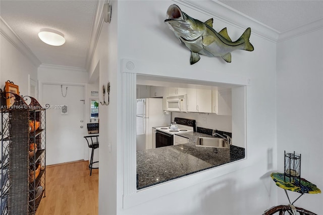 455 Paradise Isle Blvd Unit 209, Hallandale Beach, FL 33009 - kitchen featuring ornamental molding, white appliances, a sink, and light wood-style floors
