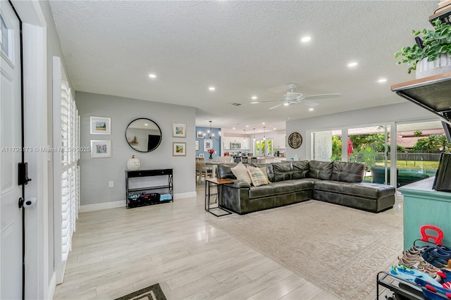 9652 NW 19th Pl, Sunrise, FL 33322 - living area with a ceiling fan, recessed lighting, light wood-style floors, a textured ceiling, and baseboards