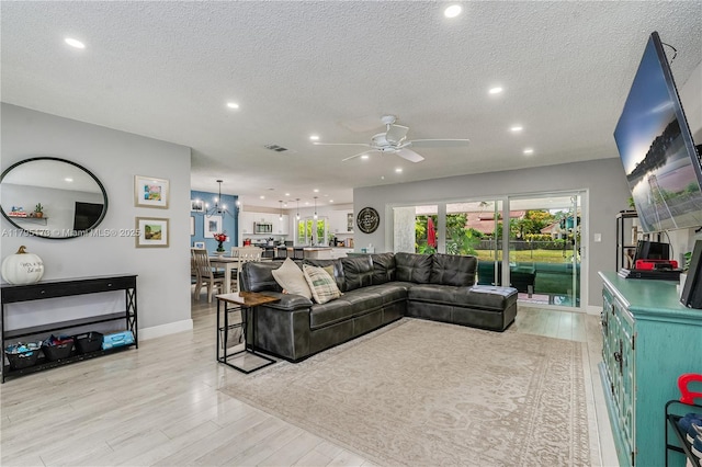 9652 NW 19th Pl, Sunrise, FL 33322 - living area with ceiling fan, light wood-type flooring, recessed lighting, baseboards, and a textured ceiling