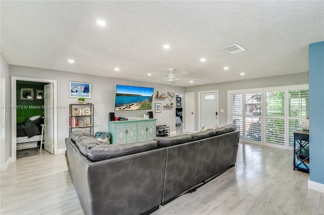 9652 NW 19th Pl, Sunrise, FL 33322 - living area featuring recessed lighting, light wood finished floors, a textured ceiling, a ceiling fan, and baseboards