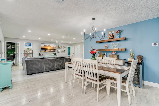 9652 NW 19th Pl, Sunrise, FL 33322 - dining space with a chandelier, light wood finished floors, a textured ceiling, recessed lighting, and baseboards