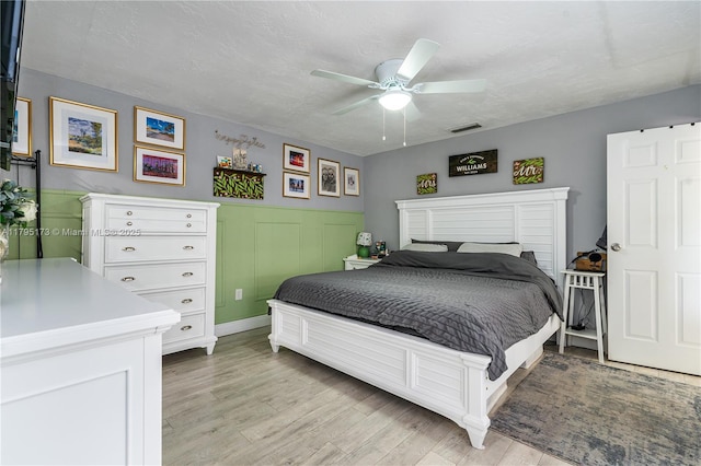 9652 NW 19th Pl, Sunrise, FL 33322 - bedroom featuring light wood finished floors, wainscoting, and a ceiling fan