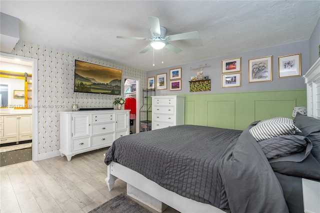 9652 NW 19th Pl, Sunrise, FL 33322 - bedroom with wood finished floors, connected bathroom, wallpapered walls, ceiling fan, and baseboards
