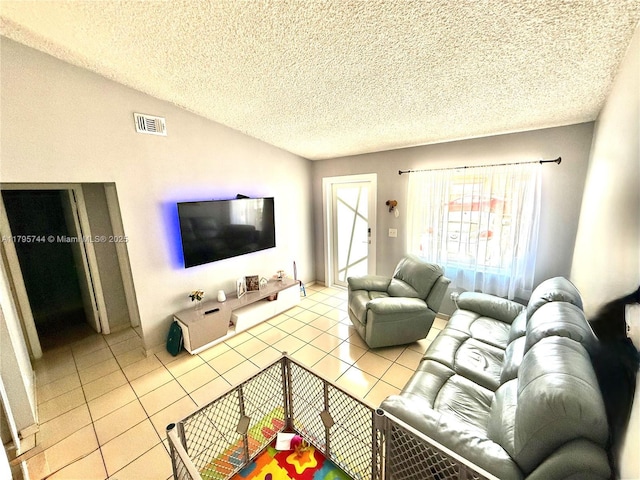 tiled living area with vaulted ceiling, a textured ceiling, and visible vents