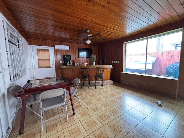 office space with wood ceiling, wooden walls, a ceiling fan, and a wall mounted AC