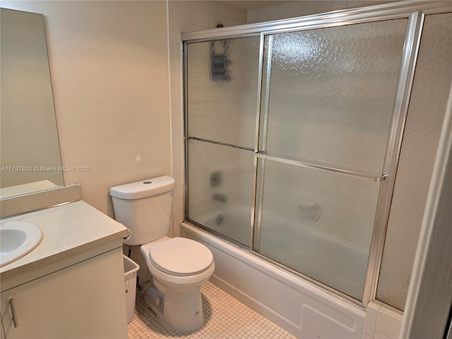full bath with bath / shower combo with glass door, tile patterned flooring, vanity, and toilet