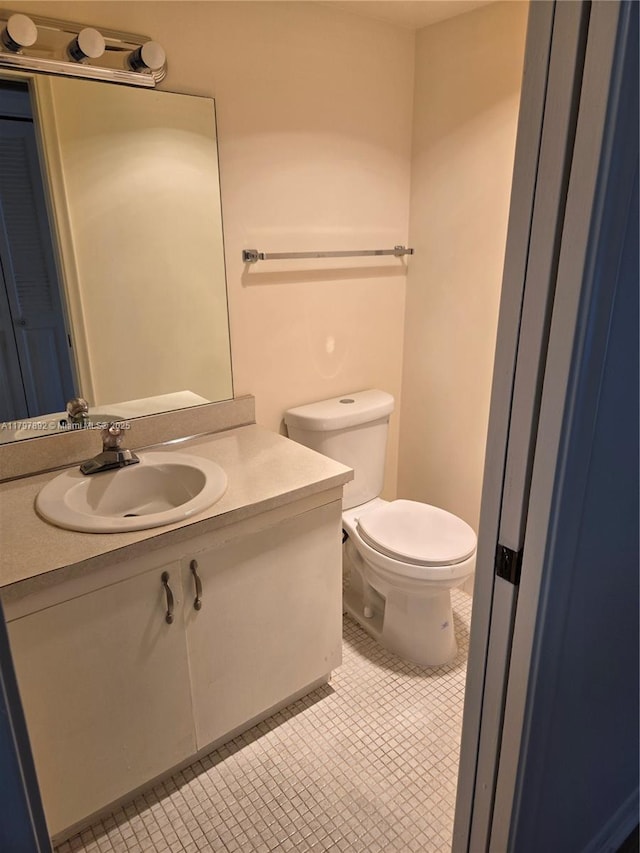 bathroom featuring toilet and vanity
