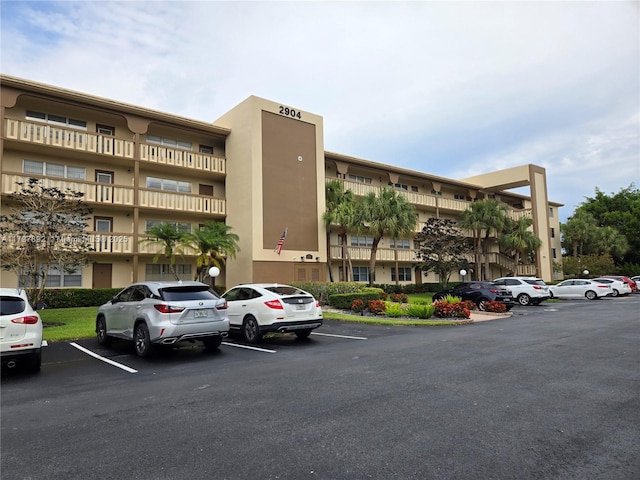 view of building exterior with uncovered parking