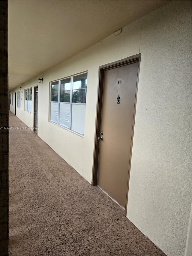 doorway to property featuring stucco siding