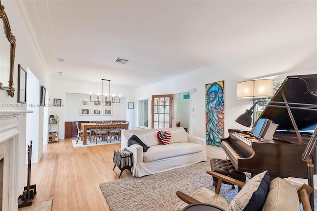 1254 Andalusia Ave, Coral Gables, FL 33134 - living room with a chandelier, ornamental molding, and light wood-style flooring