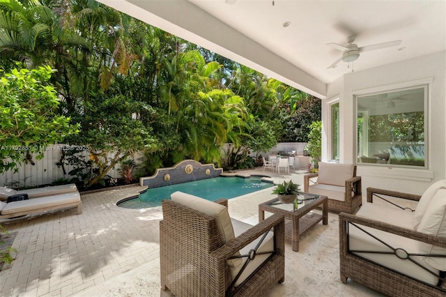 view of swimming pool featuring outdoor lounge area, a fenced backyard, ceiling fan, a patio area, and a fenced in pool
