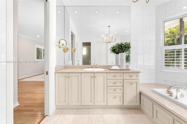 7251 SW 47th Ct, Miami, FL 33143 - bathroom featuring a chandelier, crown molding, vanity, a garden tub, and recessed lighting