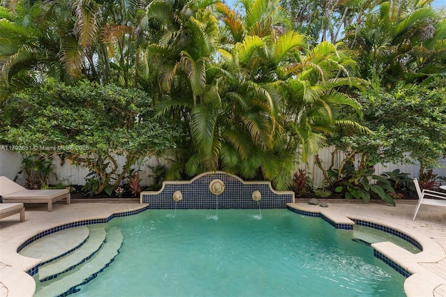 view of swimming pool with a fenced backyard and a patio area