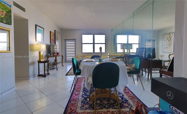 9225 Collins Ave Ph-C, Ph-C Surfside, FL 33154 - dining area with a textured ceiling and light tile patterned flooring
