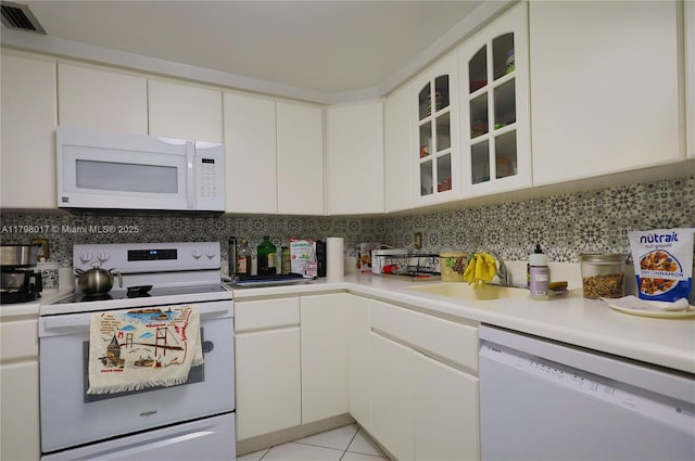9225 Collins Ave Ph-C, Ph-C Surfside, FL 33154 - kitchen with white appliances, light countertops, decorative backsplash, and white cabinetry