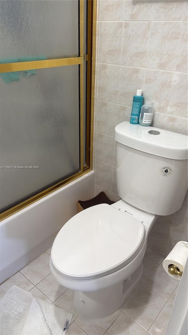 9225 Collins Ave Ph-C, Ph-C Surfside, FL 33154 - full bathroom with tile walls, tile patterned flooring, and combined bath / shower with glass door