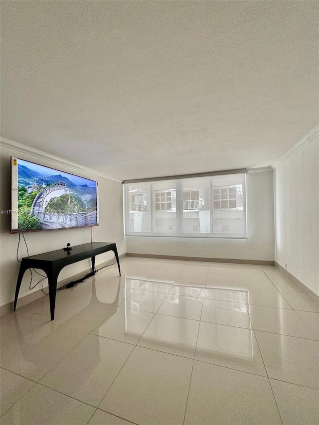 1200 W Ave Unit 209, Miami Beach, FL 33139 - unfurnished living room with crown molding, plenty of natural light, a textured ceiling, light tile patterned floors, and baseboards