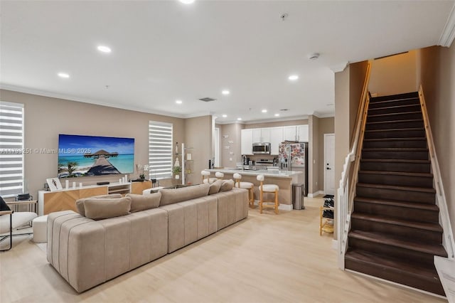 living area featuring crown molding, visible vents, stairway, and recessed lighting