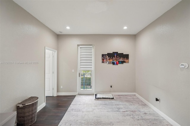 unfurnished room featuring recessed lighting, baseboards, and dark wood-style floors