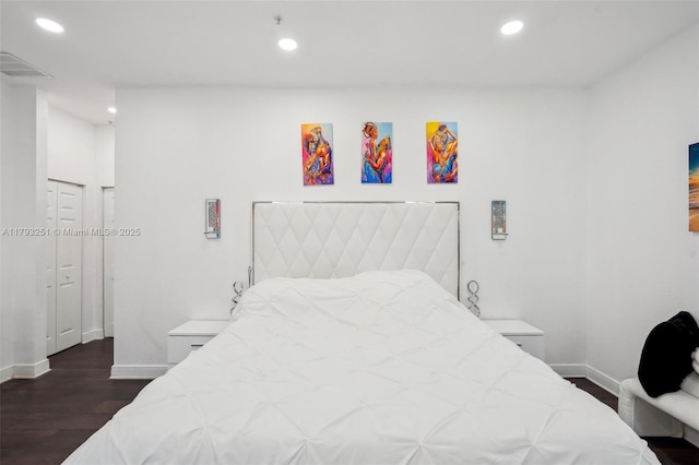 bedroom with dark wood finished floors, visible vents, baseboards, and recessed lighting