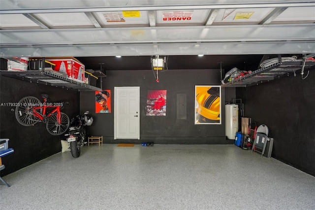 garage with water heater and a garage door opener