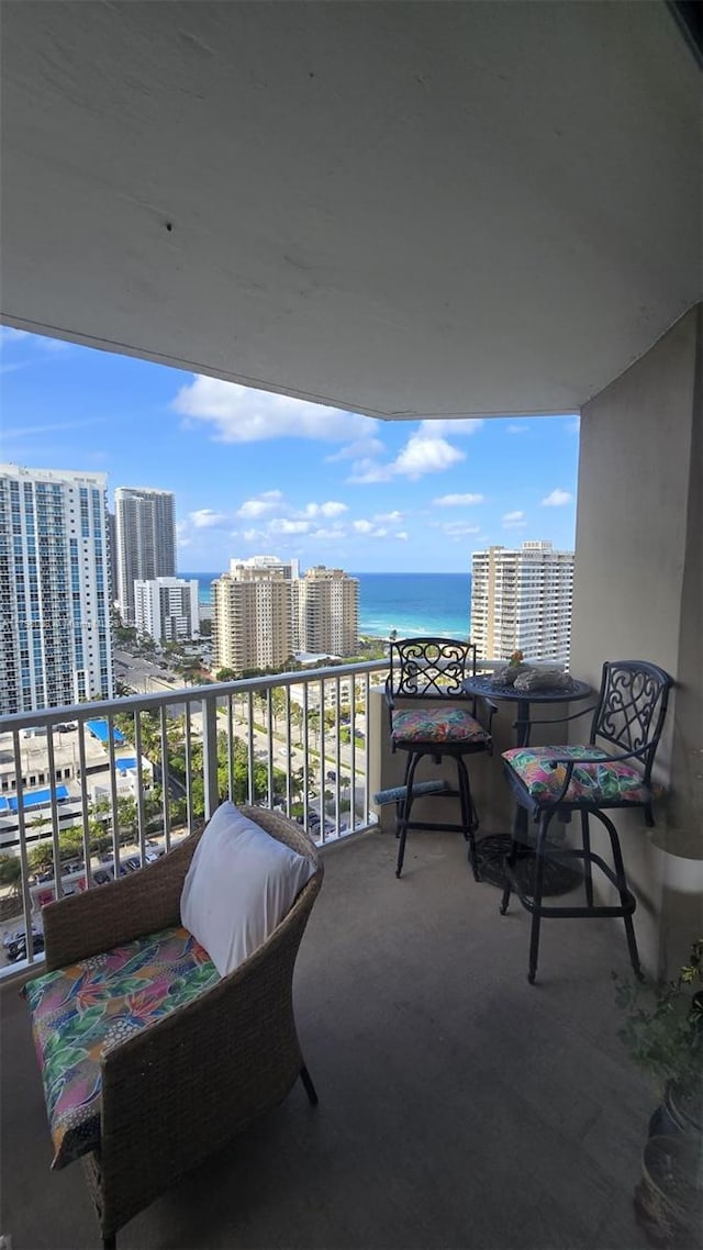 balcony featuring a water view and a view of city