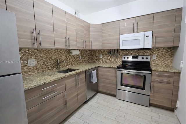 1985 S Ocean Dr Unit 21D, Hallandale Beach, FL 33009 - kitchen with stainless steel appliances, tasteful backsplash, and light stone countertops