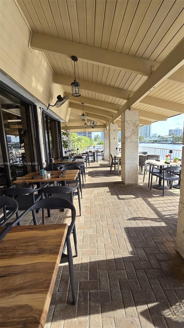 view of patio / terrace with a water view and outdoor dining area