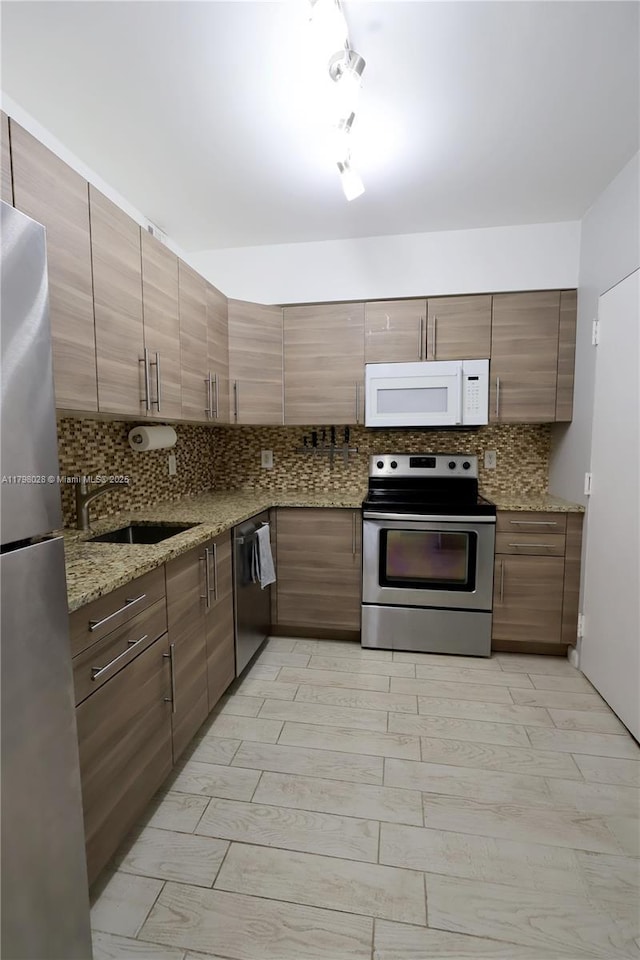 1985 S Ocean Dr Unit 21D, Hallandale Beach, FL 33009 - kitchen with appliances with stainless steel finishes, backsplash, and light stone counters