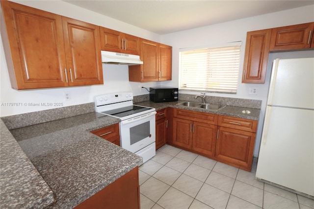 kitchen with brown cabinets, a sink, white appliances, under cabinet range hood, and light tile patterned flooring